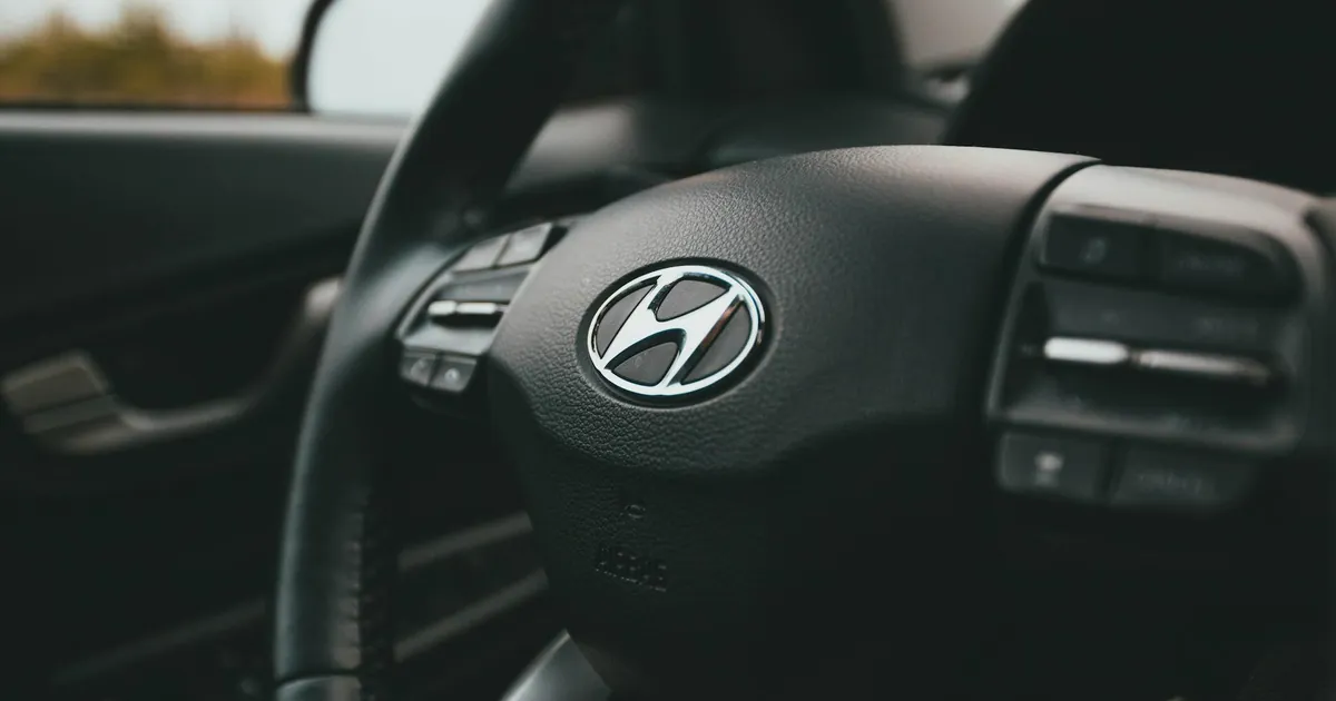 A close-up image focusing on a Hyundai steering wheel inside a car, highlighting design details.