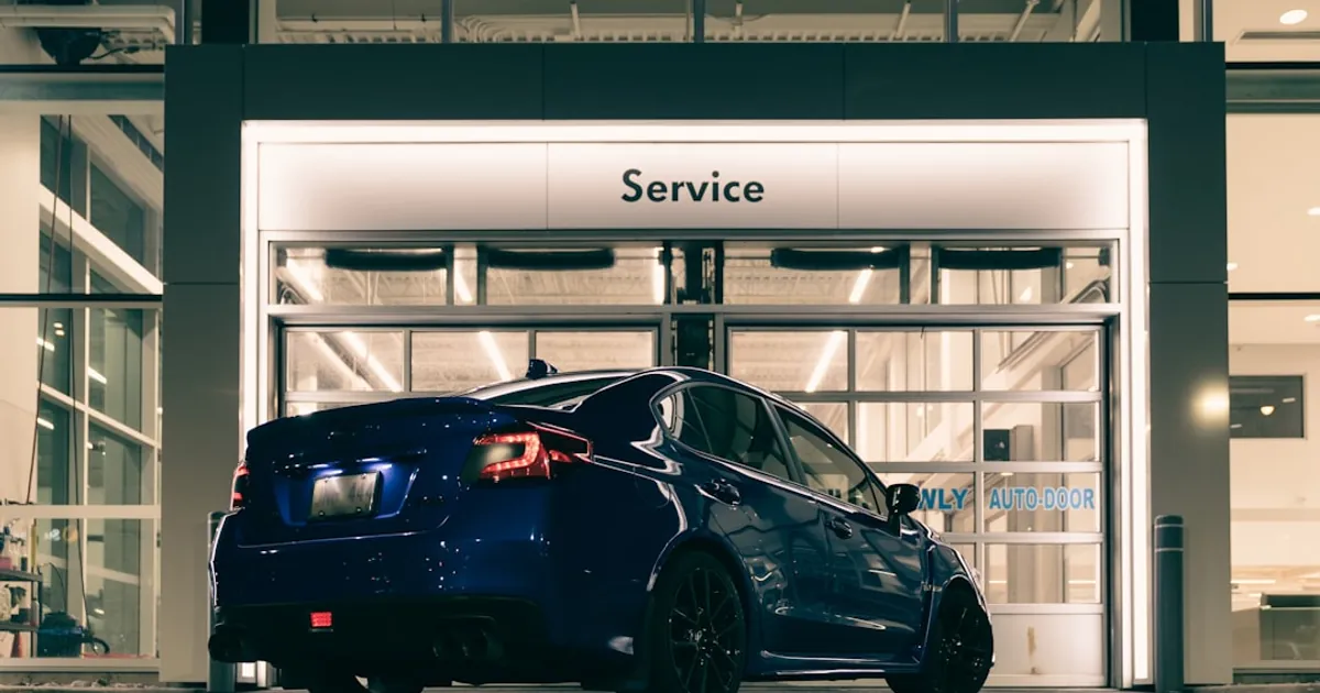 A blue car parked in front of a building