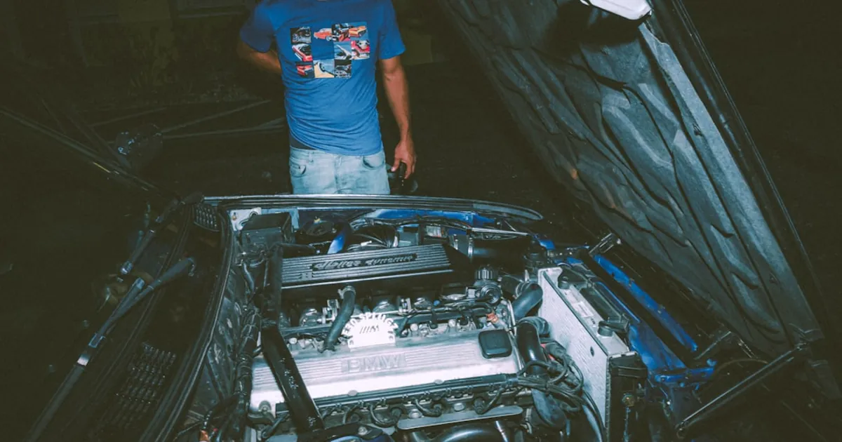 a man standing next to a car engine