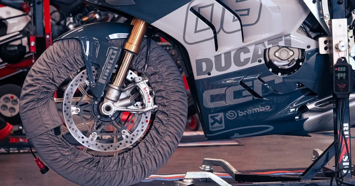 A motorcycle's tire with a cover is pictured.