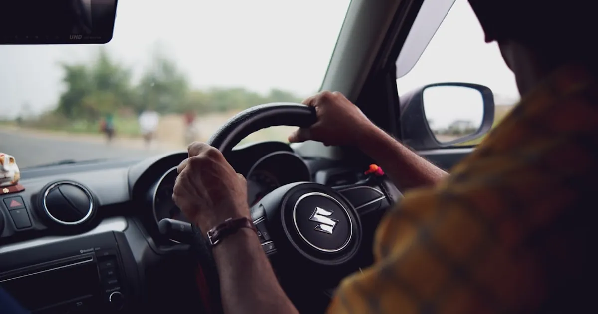 a man driving a car down a street