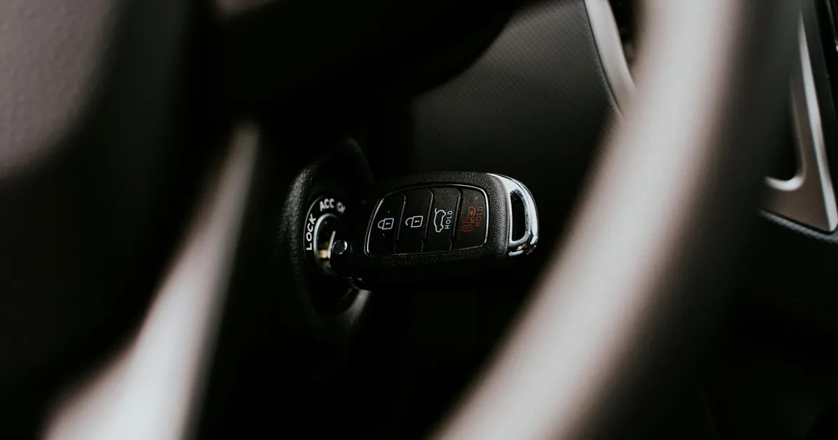 A close-up view of a car key placed in the ignition inside a vehicle, highlighting automotive detail.