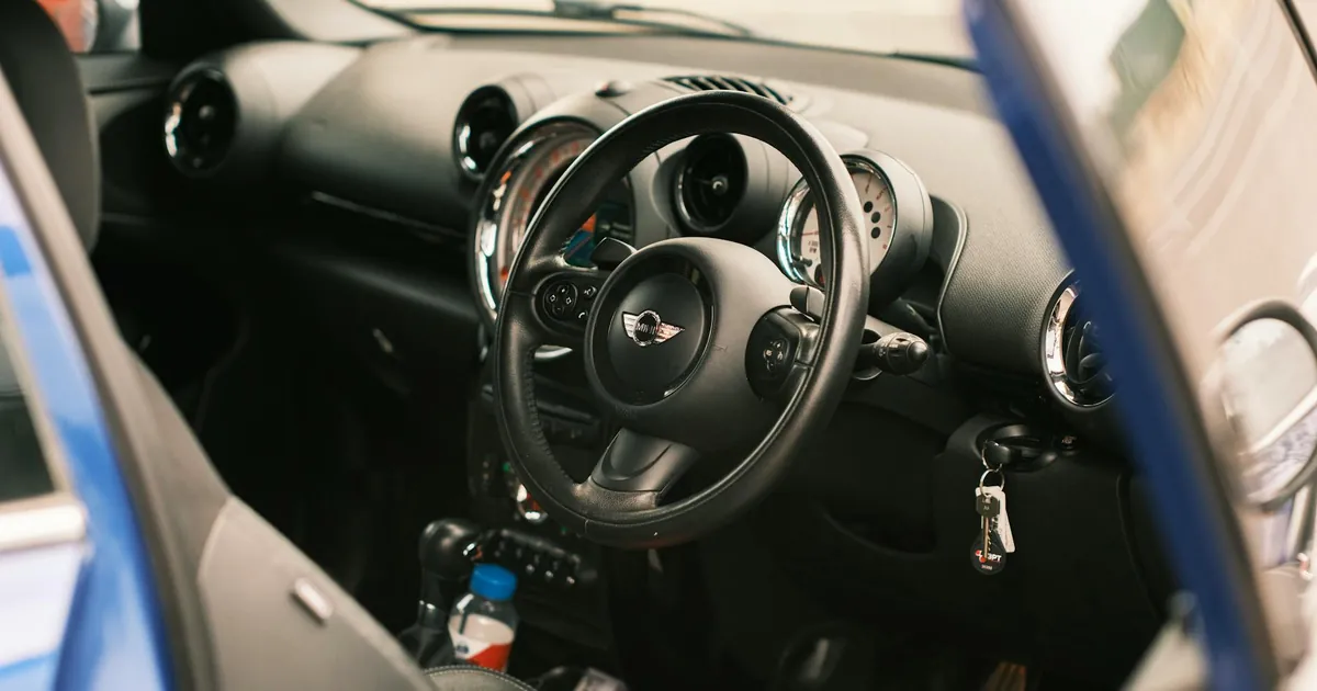 Close-up of a Mini Cooper S interior featuring a steering wheel and dashboard in Melbourne, Australia.