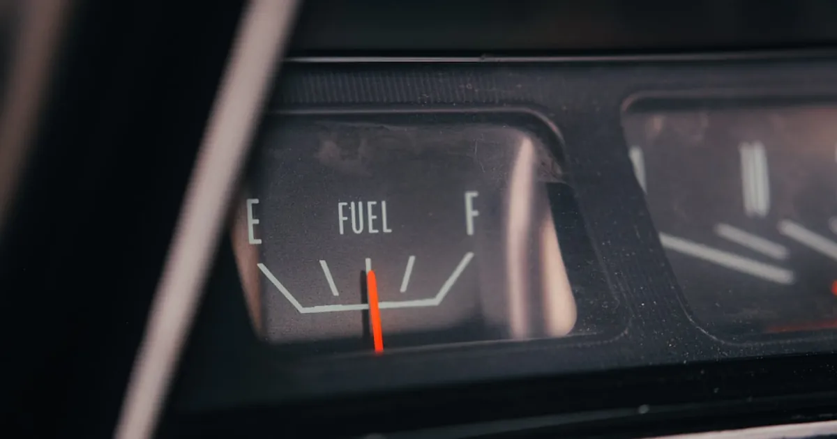 Close-up of a car's fuel gauge showing empty