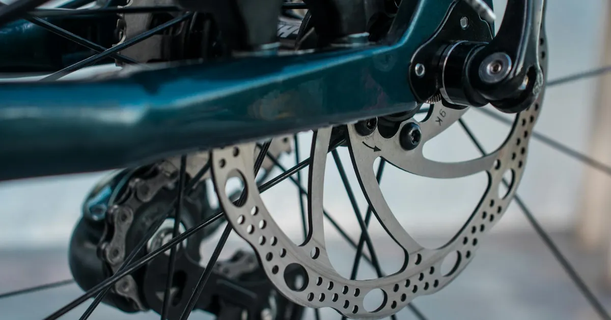 Detailed view of a bicycle brake rotor and caliper mechanism for cycling enthusiasts.