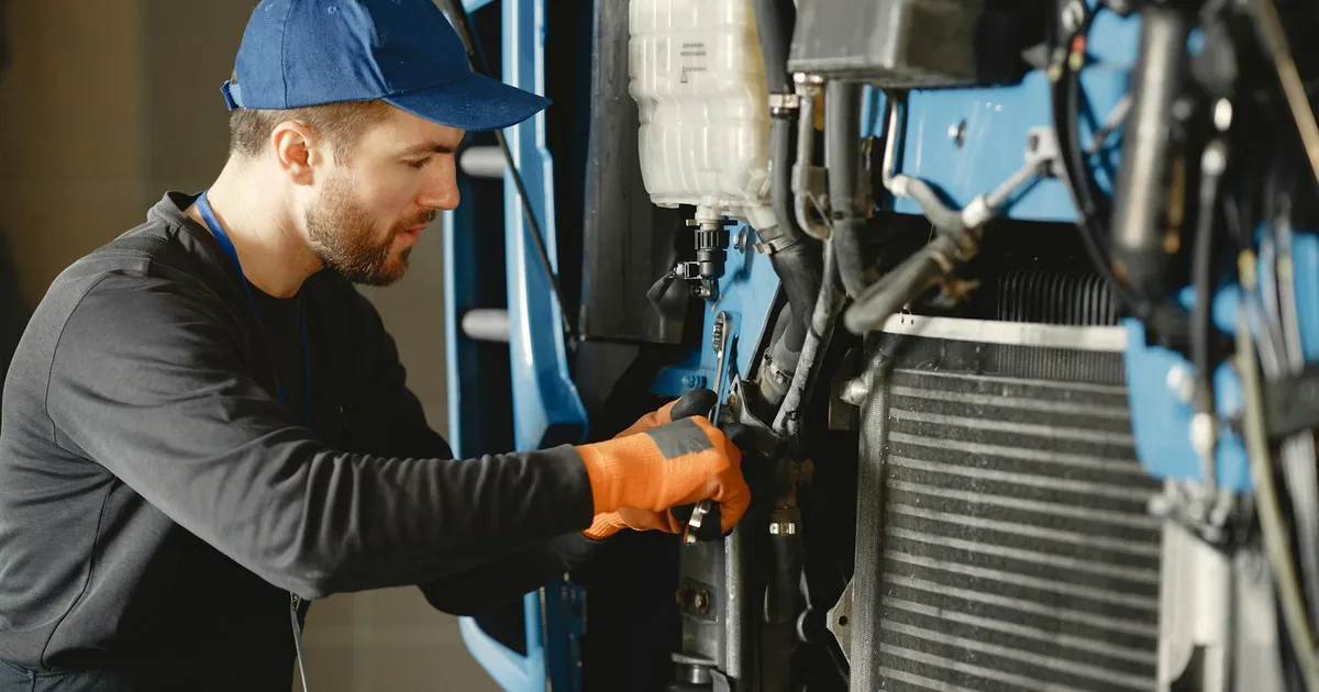 Mechanic repairing a machine with precision, showcasing industrial expertise.