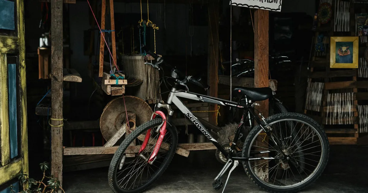A rural shop with bicycles for rent and a traditional loom, conveying a rustic vibe.
